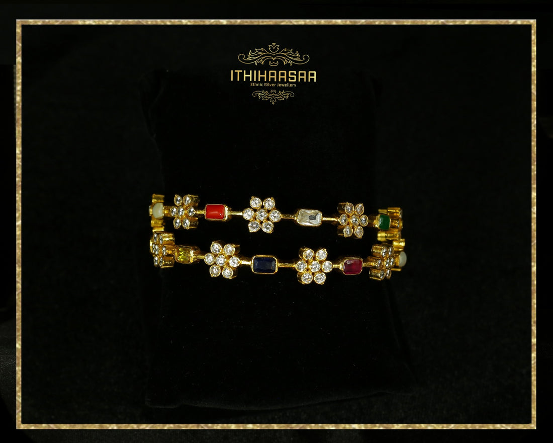 A Pair of navaratan Banngle in cz stones with floral motif made with 92.5 silver
