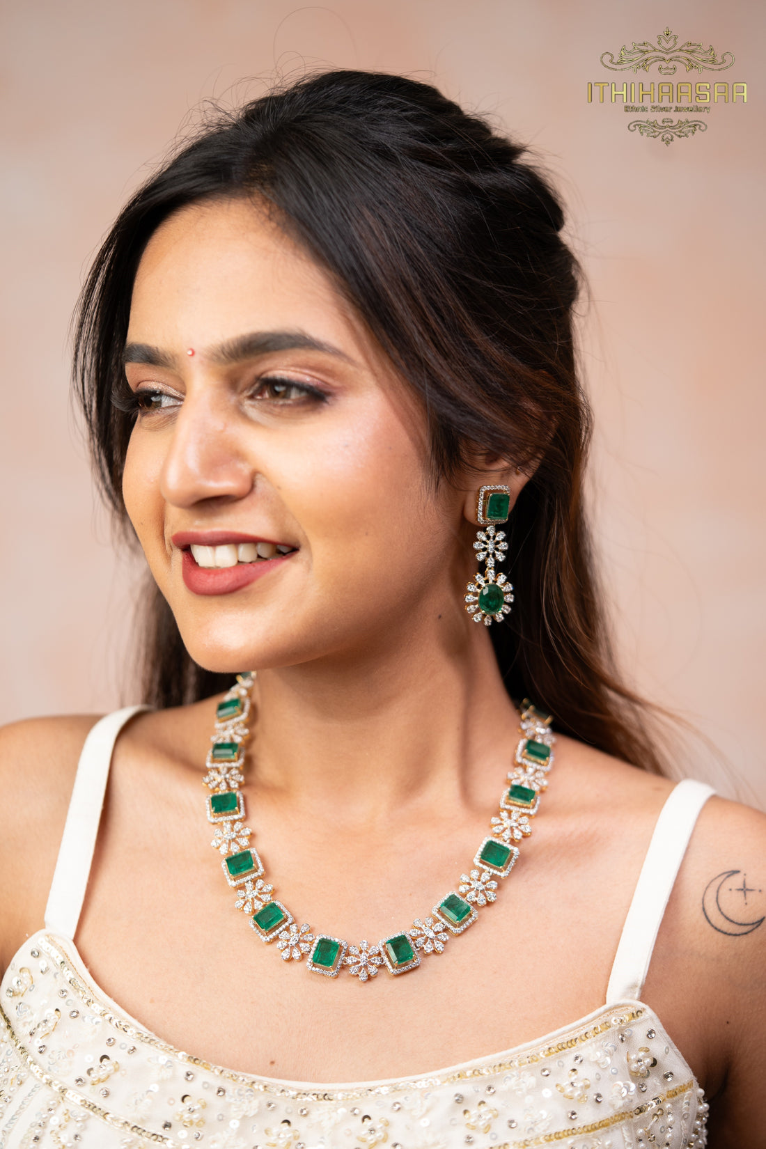 CZ stones in floral motif with shimmering emeralds paired with long earrings