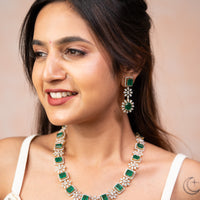 CZ stones in floral motif with shimmering emeralds paired with long earrings