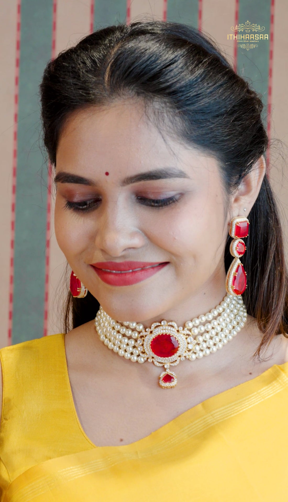 Pearl choker studded with bright ruby stones as a statement paired with ruby stone earrings